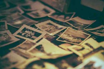 Pictures scattered on the table depicting past memories and nostalgia.