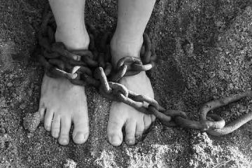 Chain tied to the legs suggesting slavery, depression, and misery.