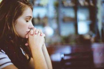 A woman praying for hope and inspiration in life.