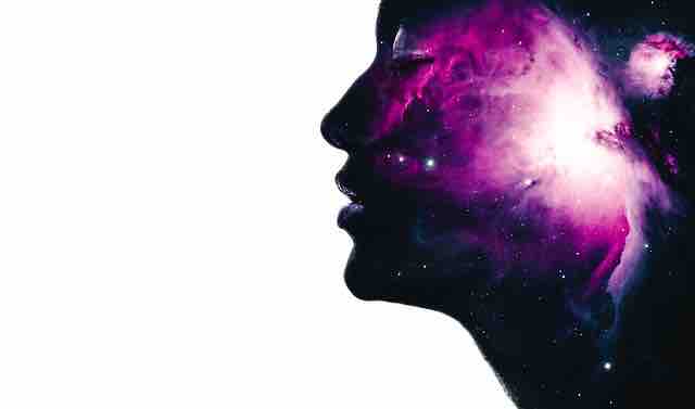 Picture of a woman with image of galaxy in her head depicting optimism and inspiration in life.