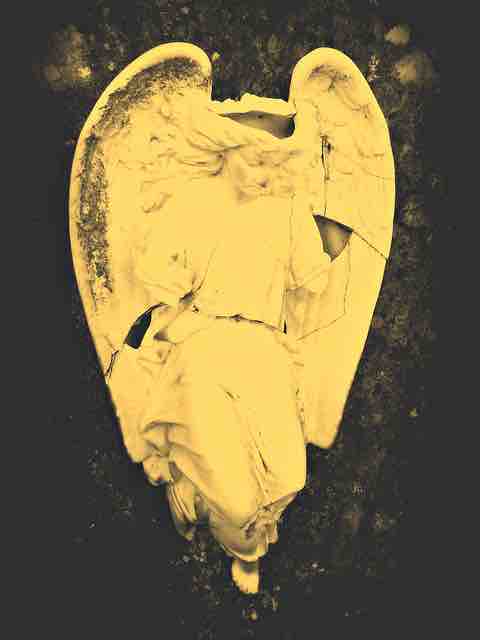 A broken statue of a sad angel depicting broken faith, lost belief, and misery.