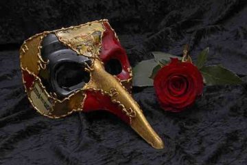 A beak mask with a rose by the side showcasing hidden identity of a depressed person, pain, and misery.