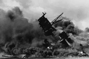 A shipwreck in the sea with smoke around due to the bombings on Pearl Harbor by the Japanese Air Force in World War 2.