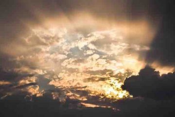 Sun rays penetrating through the cloudy sky depicting hope.